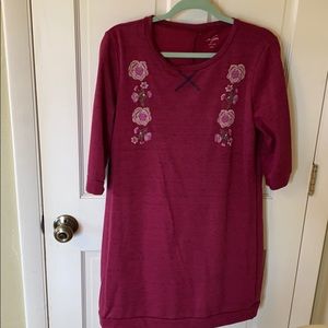 Maroon dress with floral embroidery.